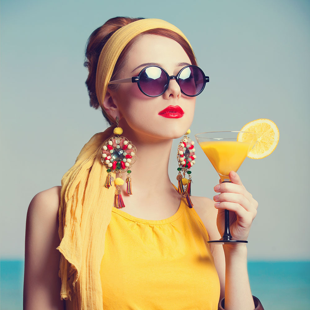 woman with a drink in sunglasses